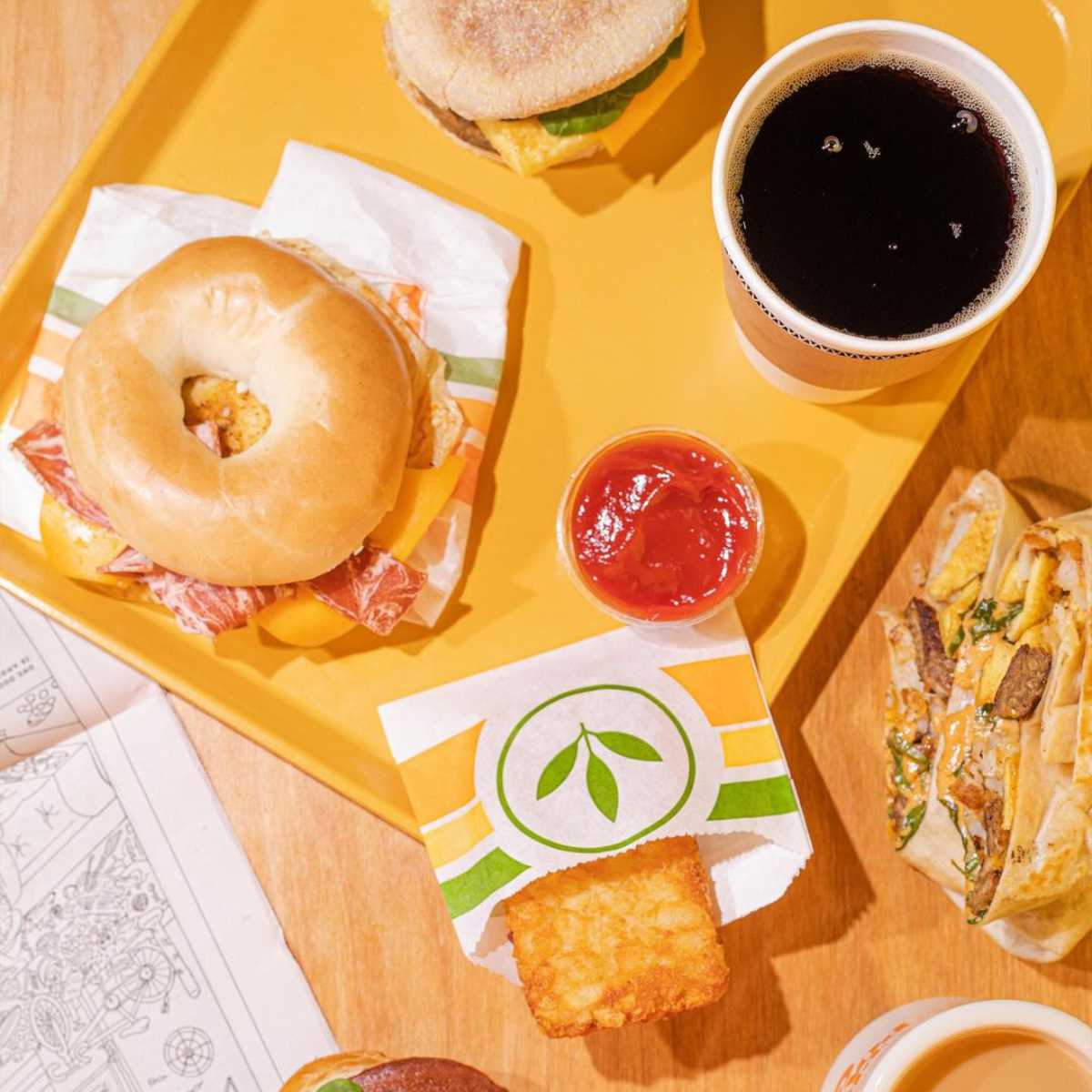 cup of coffee next to a selection of vegan fast food