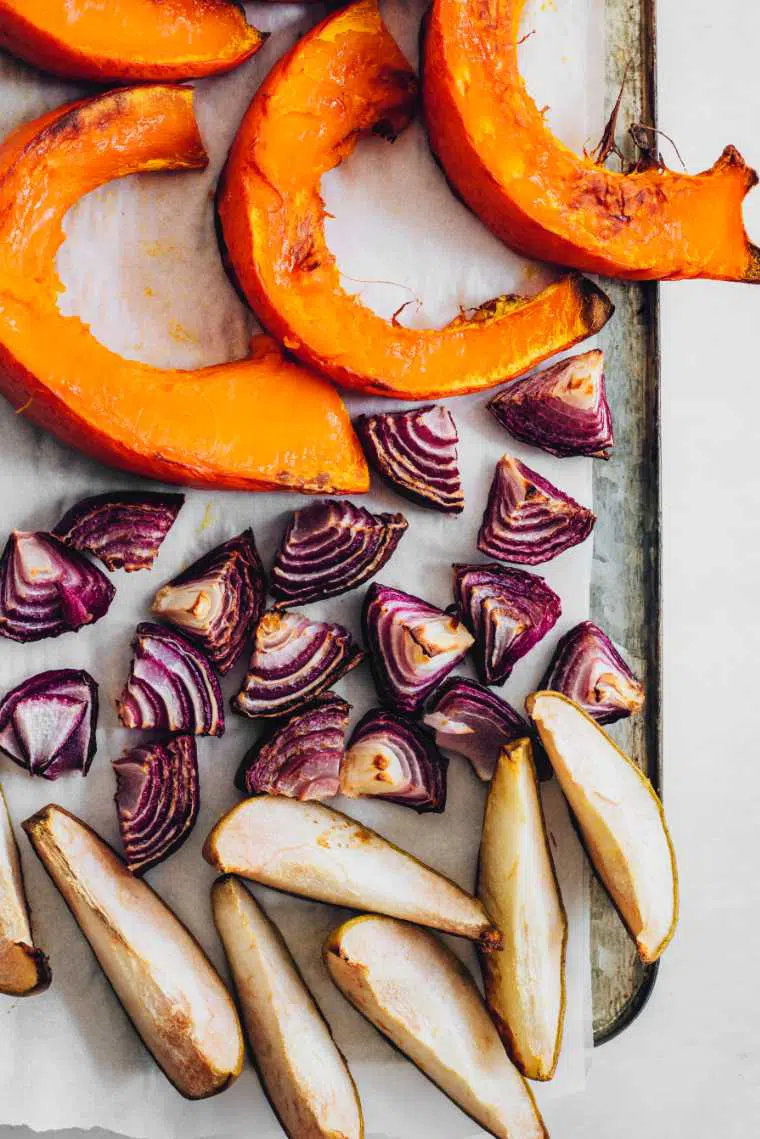 lined baking sheet with roasted pumpkin, onion and pears