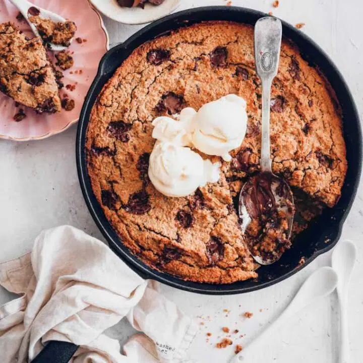baking pan with warm vegan cookie cake and coconut ice cream