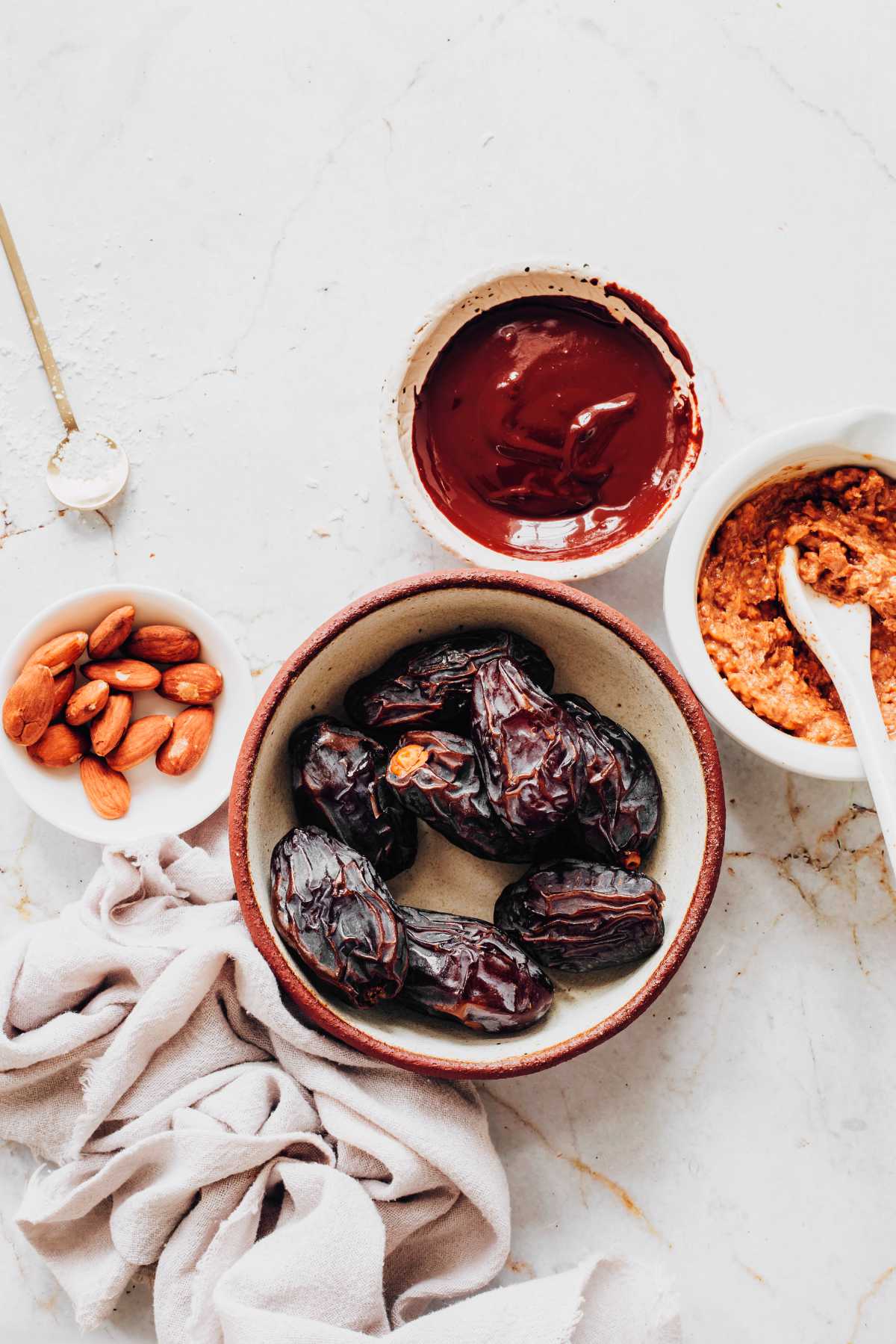 dates, chocolate and peanut butter on a table
