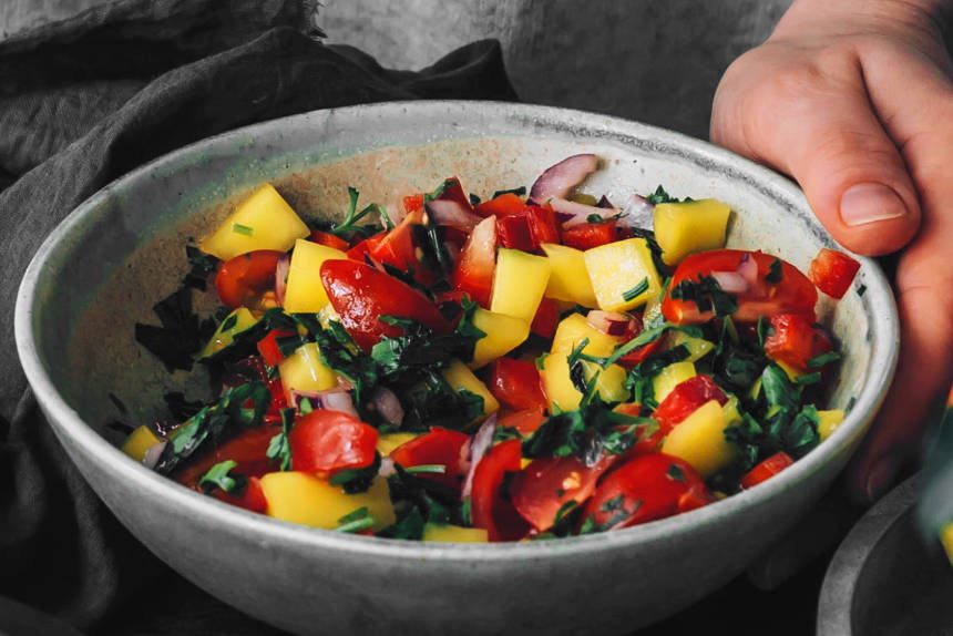close up of a bowl with freshly made spicy mango tomato salsa