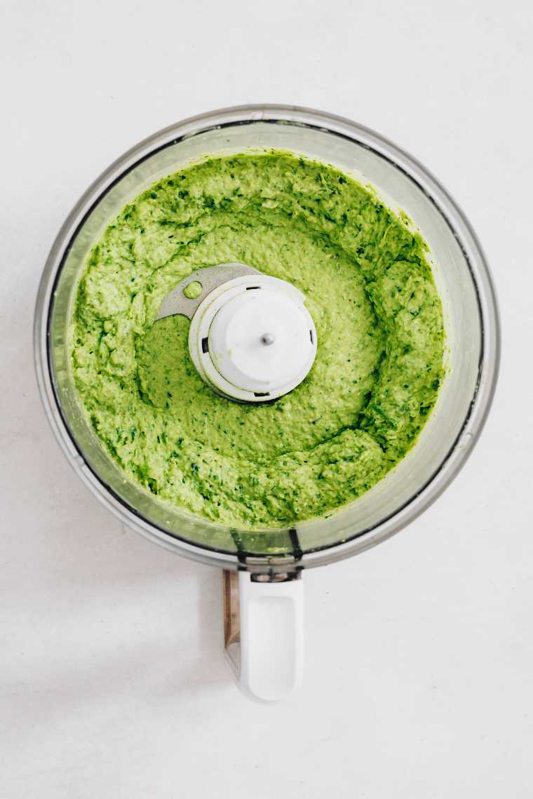 food processor with creamy green goddess hummus