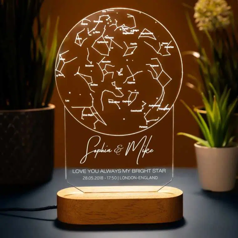wooden stand with an acrylic lamp showing star constellation and two names