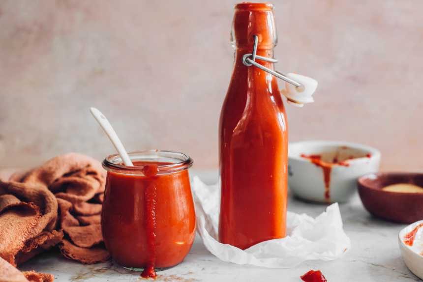 two glasses of homemade vegan ketchup on a table