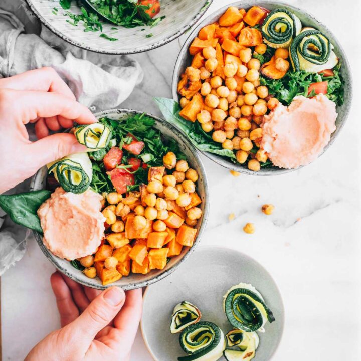 two sweet potato nourish bowls with chickpeas and greens