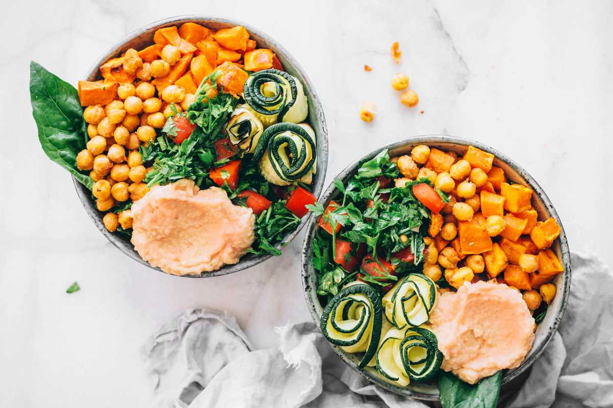 top view of two sweet potato chickpea bowls with veggies