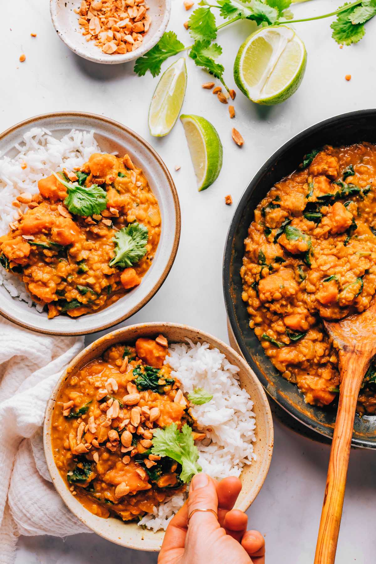 decorating sweet potato curry with herbs and peanuts