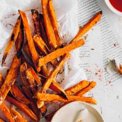 Vegan sweet potato fries next to dips