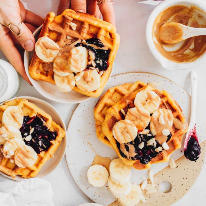 Vegan Sweet Potato Waffles with toppings on different plates