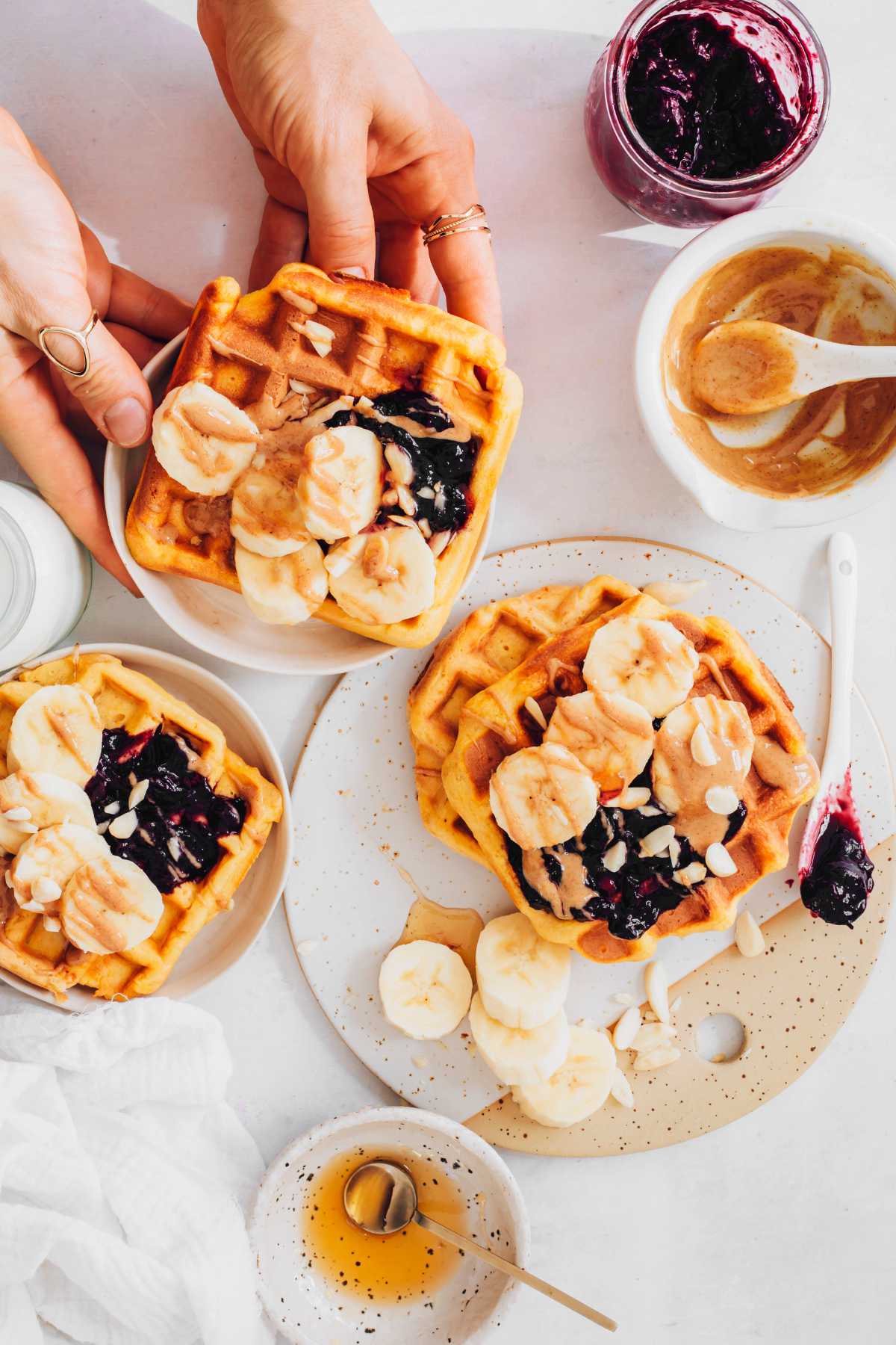Vegan Sweet Potato Waffles with toppings on different plates