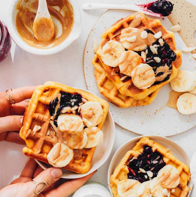 several Vegan Sweet Potato Waffles with sweet toppings