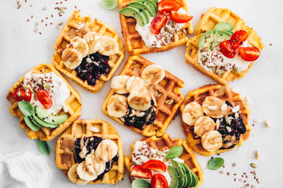 table with colorful sweet and savory waffle toppings