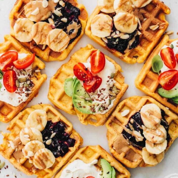 hearty vegan waffles being topped with sweet and savory toppings