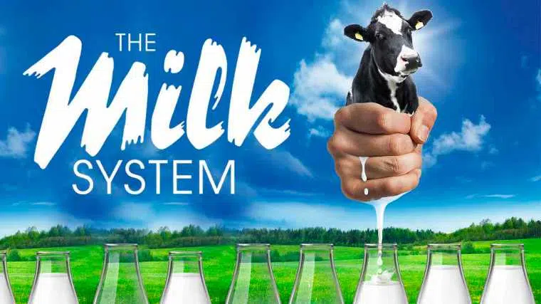 Hand squeezing an entire cow to fill a bottle with milk and text The Milk System