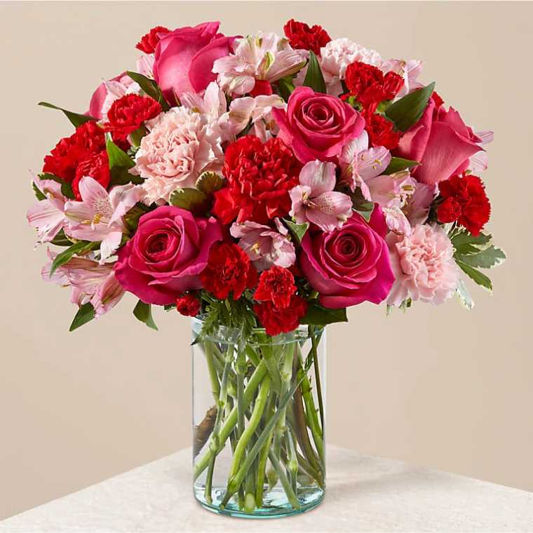 pink flower bouquet in a large vase on a table