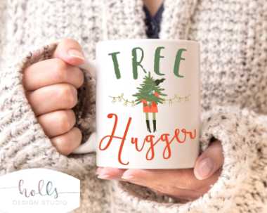 woman in cozy sweater holding a white mug that says "tree hugger"