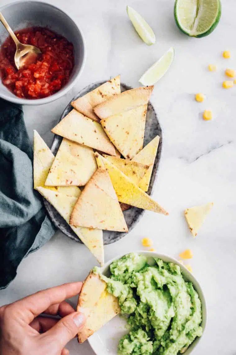 Vegan Guacamole with Chips and salsa on a table