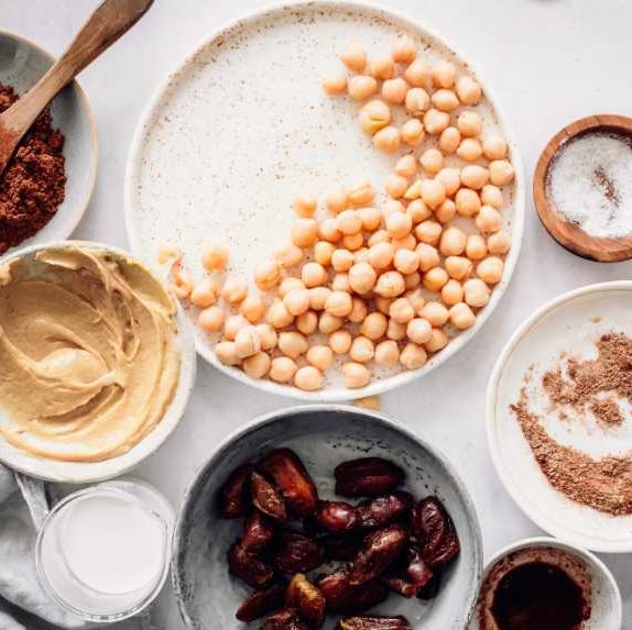 vegan staple foods, such as chickpeas, dates, flaxseeds and spices on a table