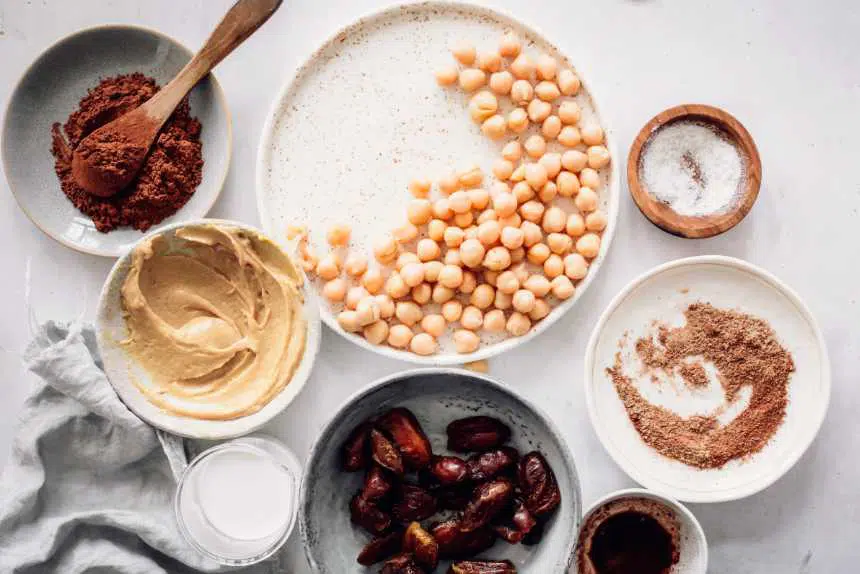 vegan staple foods, such as chickpeas, dates, flaxseeds and spices on a table