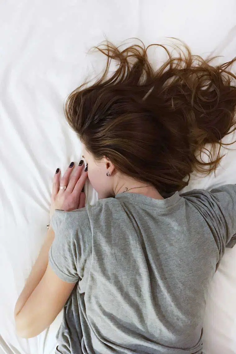 Brown Haired Woman Lying Face Down on Bed and Sleeping
