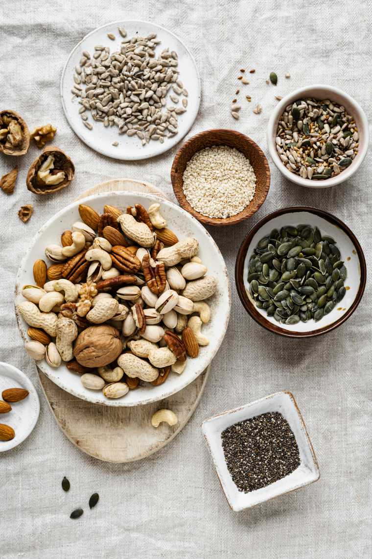 different types of nuts and seeds on a table