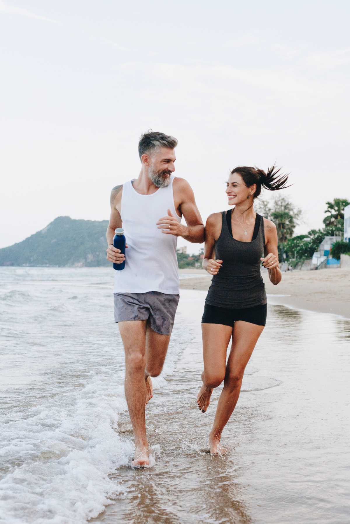 man and woman running together and having fun